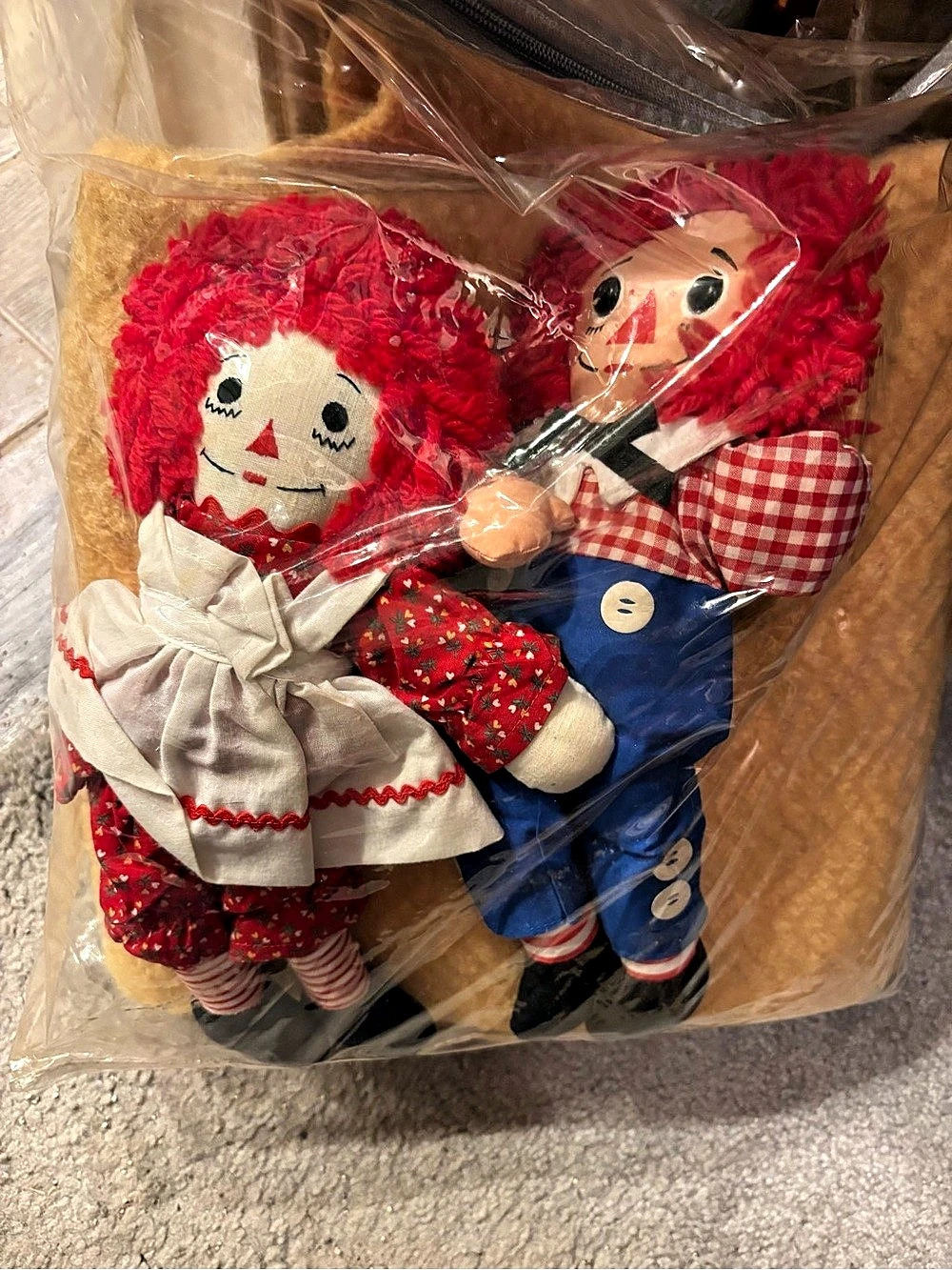 Raggedy Ann and Andy Dolls and a vintage throw